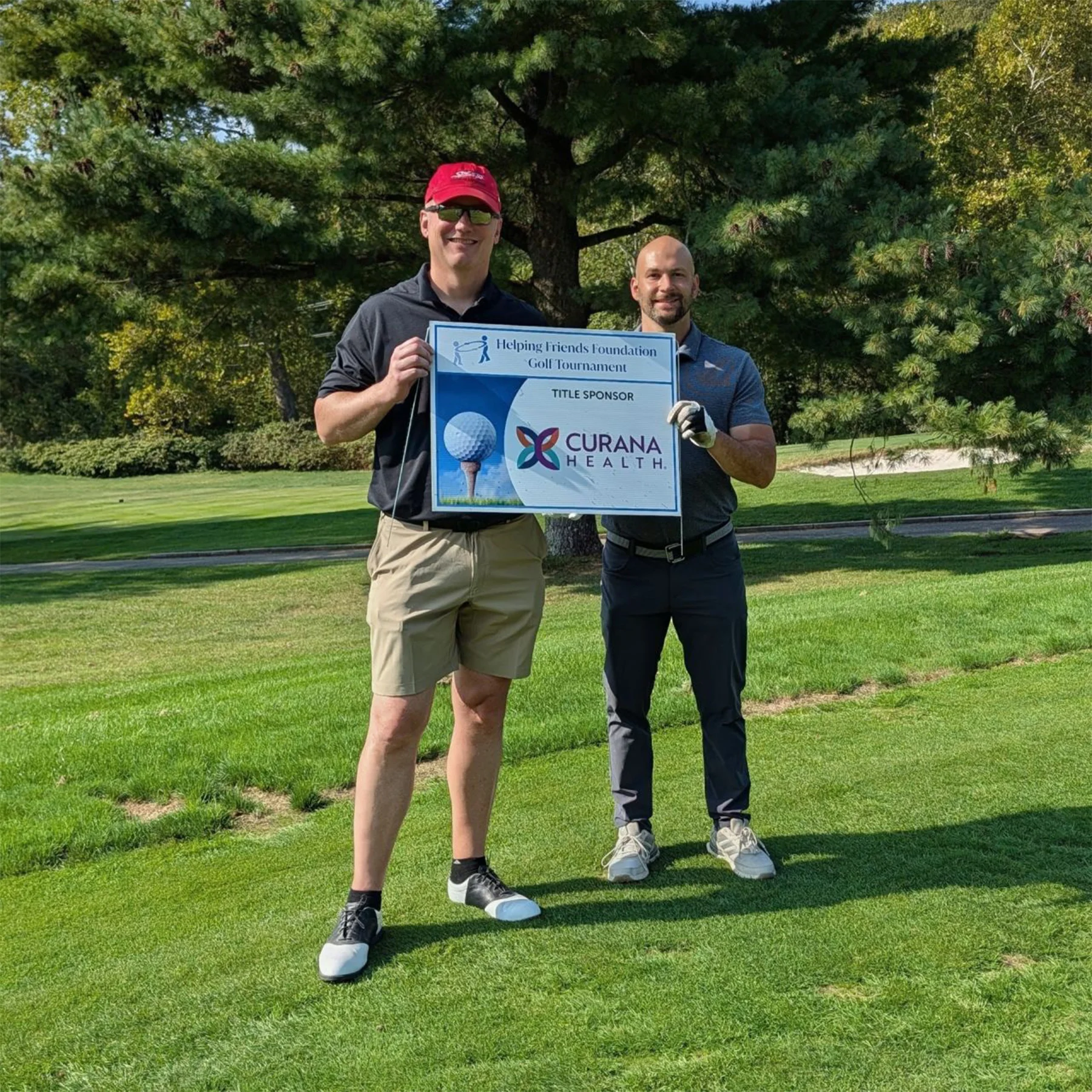 Curana team giving check to the Helping Friends Foundation