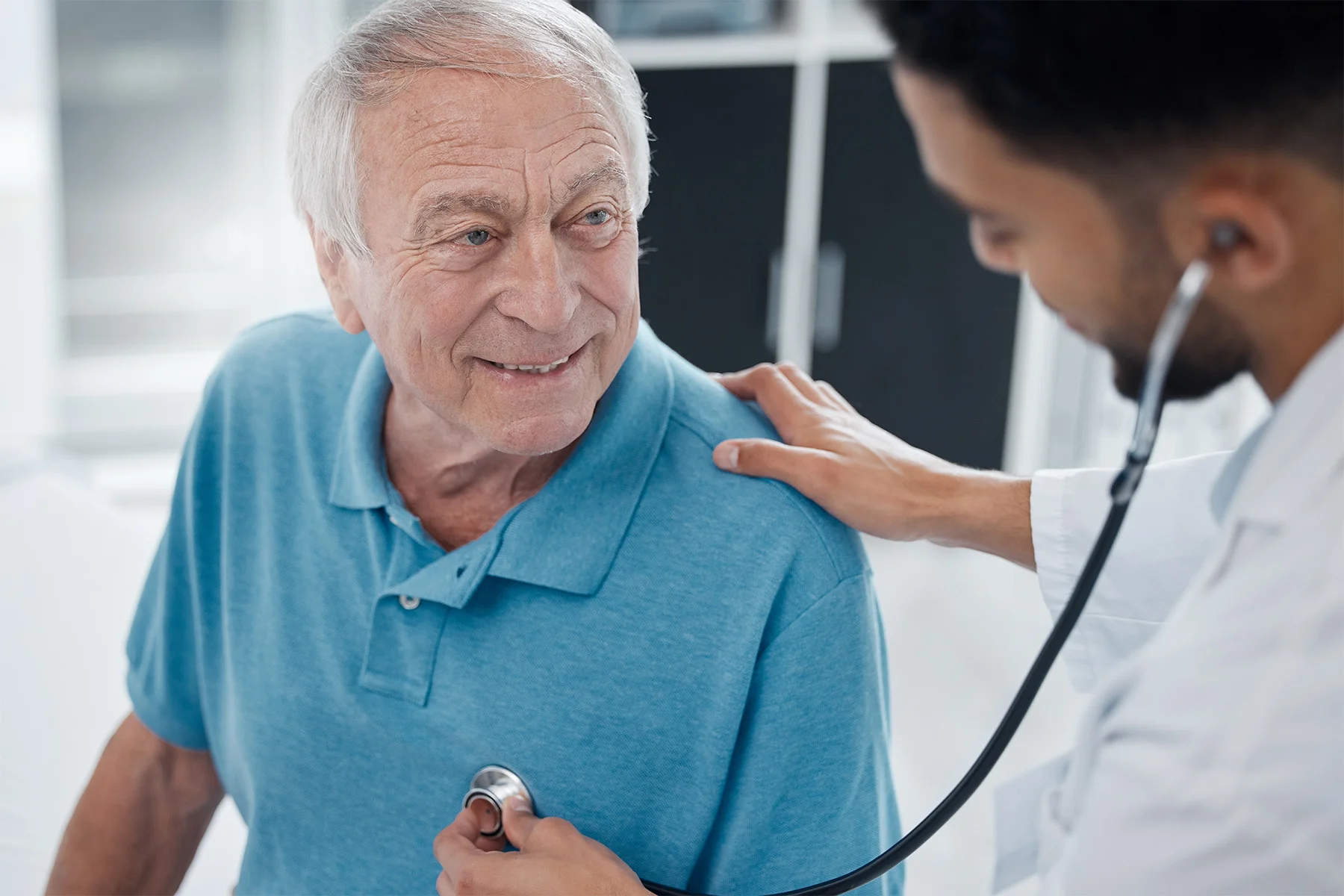 CCRC - Doctor using stethoscope to listen to senior resident's heart