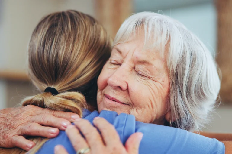 Senior hugging loved one
