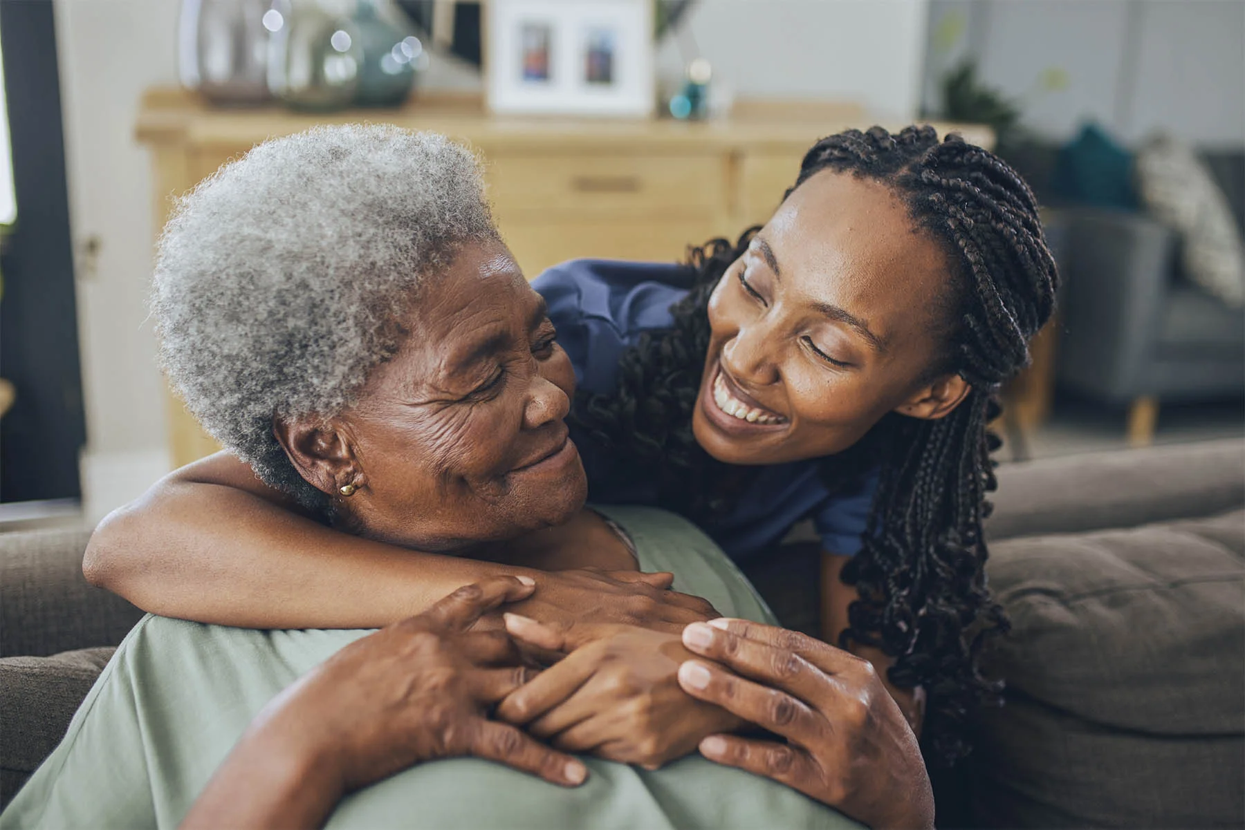 Caretaker hugging elderly woman