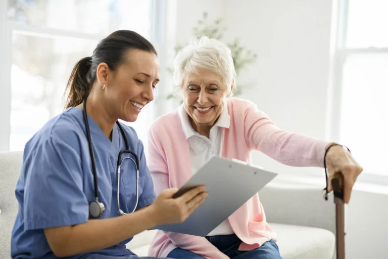 Nurse showing senior resident paperwork on clipboard