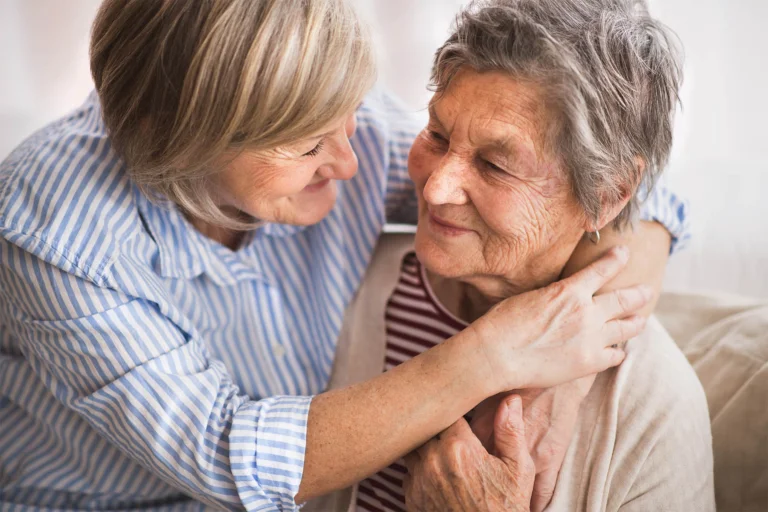 Two senior women happily embracing